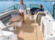 A couple relaxing aboard a modern boat at a marina.