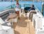 A couple relaxing aboard a modern boat at a marina.